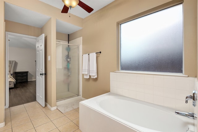 bathroom with separate shower and tub, tile patterned floors, and ceiling fan