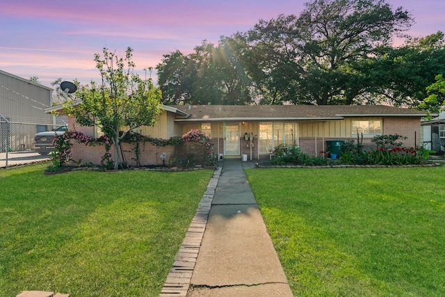 view of front of property with a yard