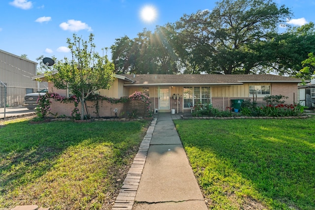 ranch-style home featuring a front yard