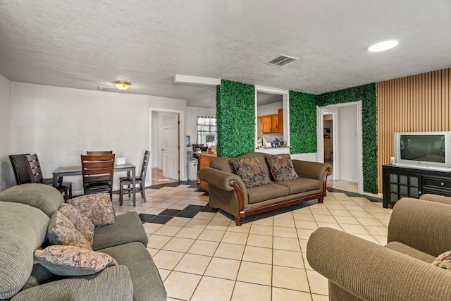 tiled living room with a textured ceiling