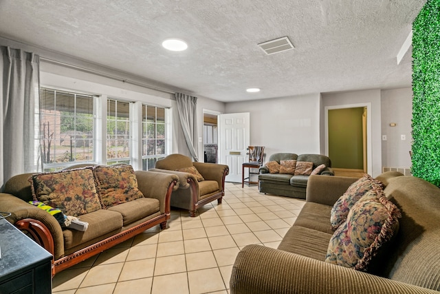 living room with light tile patterned flooring and a textured ceiling