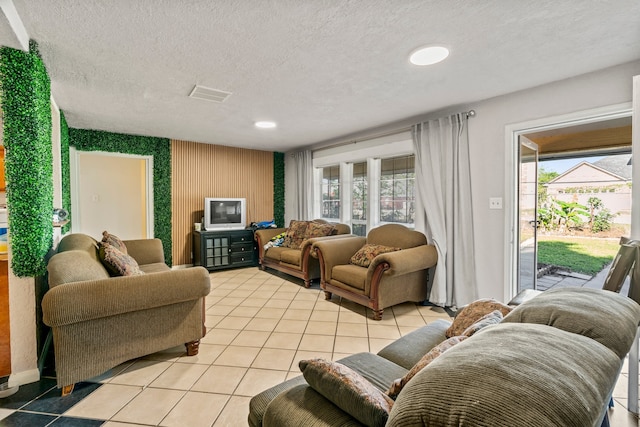 living room featuring light tile patterned floors and a textured ceiling