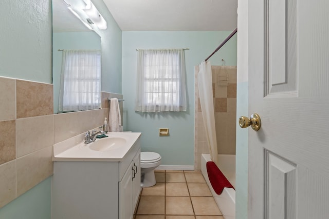 full bathroom featuring vanity, tile patterned floors, shower / bath combo with shower curtain, and toilet