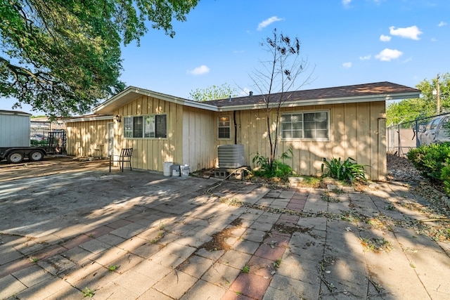 rear view of property with cooling unit and a patio area