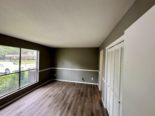 interior space featuring a textured ceiling and hardwood / wood-style flooring