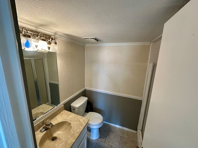 bathroom featuring crown molding, a textured ceiling, toilet, tile patterned floors, and vanity