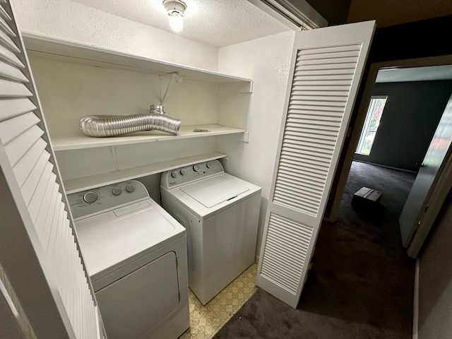 clothes washing area featuring independent washer and dryer, carpet flooring, and a textured ceiling