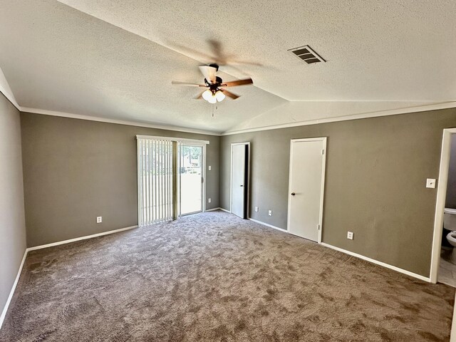 unfurnished room featuring ornamental molding, ceiling fan, carpet flooring, and vaulted ceiling