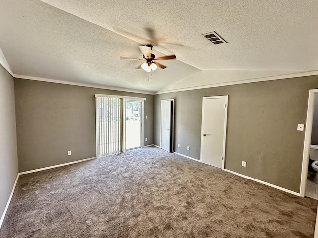 unfurnished bedroom with carpet, vaulted ceiling, ceiling fan, and a textured ceiling