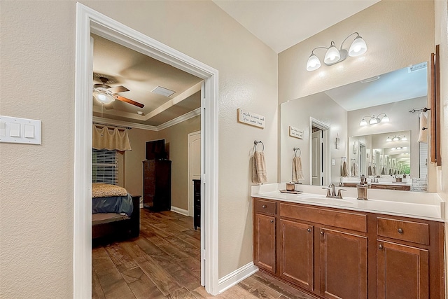 bathroom featuring vanity, wood-type flooring, ceiling fan, and crown molding