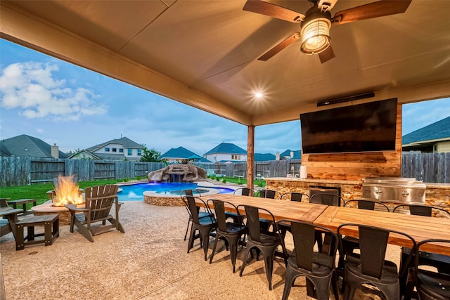 view of patio featuring pool water feature, a fenced in pool, and an outdoor fire pit