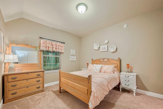 bedroom with carpet and vaulted ceiling