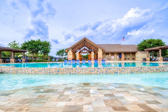 view of swimming pool featuring a pergola and an outdoor structure