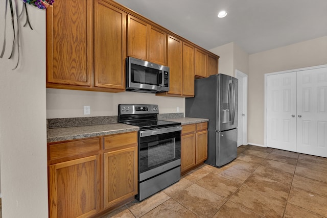 kitchen with light tile patterned flooring and stainless steel appliances