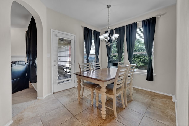 dining area with light tile patterned flooring and a chandelier