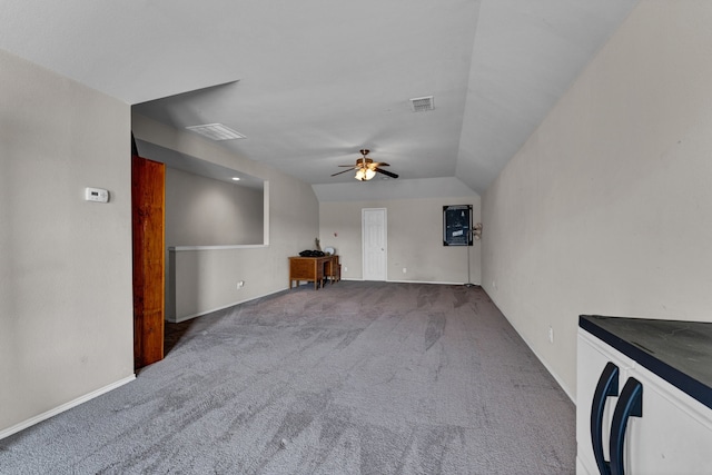 unfurnished living room with vaulted ceiling, carpet flooring, and ceiling fan