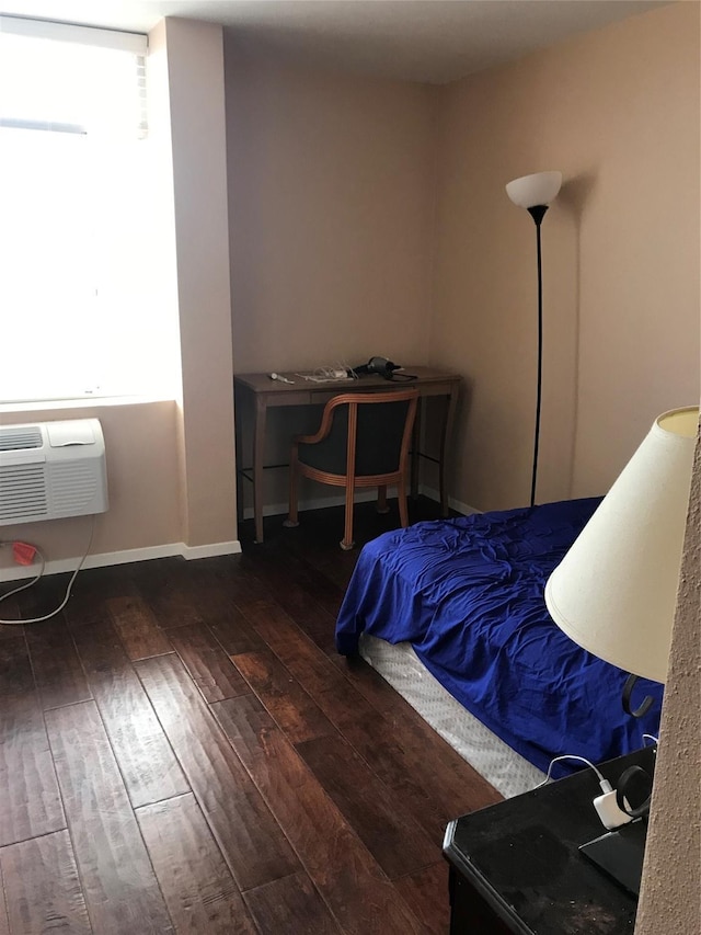 7510 Hornwood Dr Unit 201, Houston, TX 77036 - bedroom featuring wood-type flooring and an AC wall unit