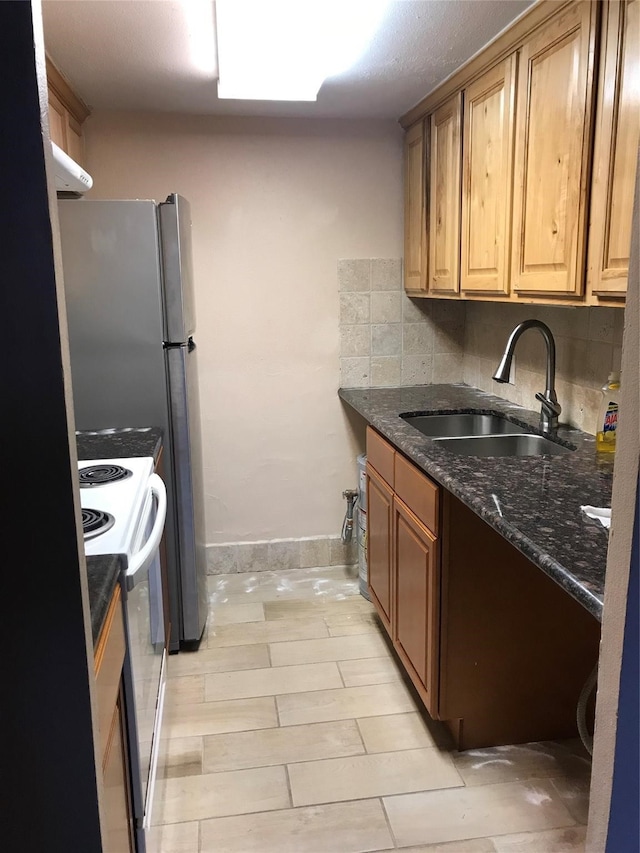 kitchen with sink, decorative backsplash, white electric range, and dark stone counters