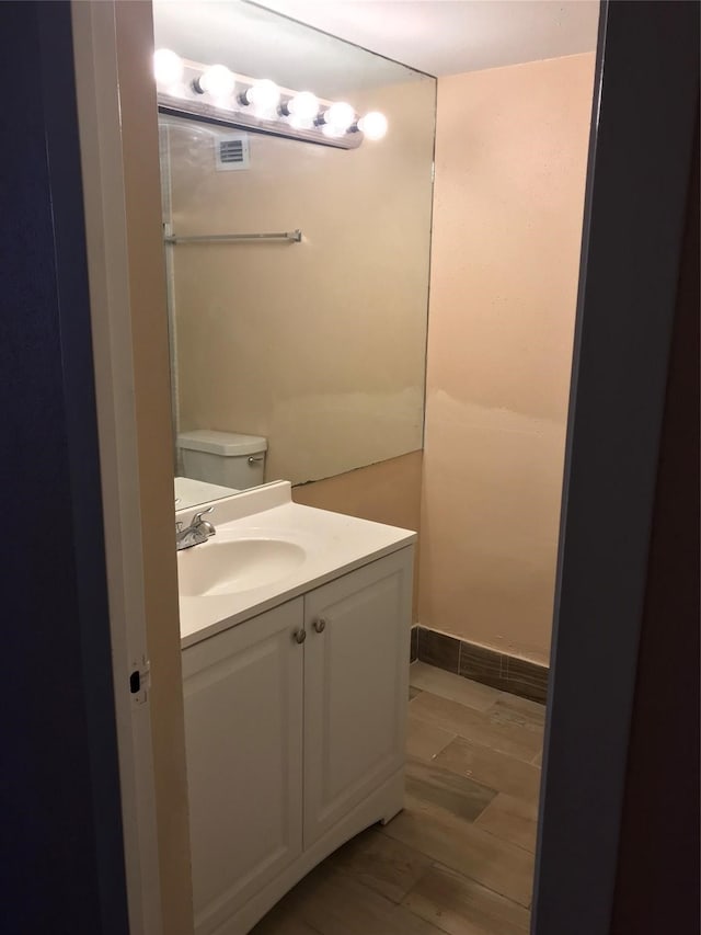 bathroom featuring toilet and vanity