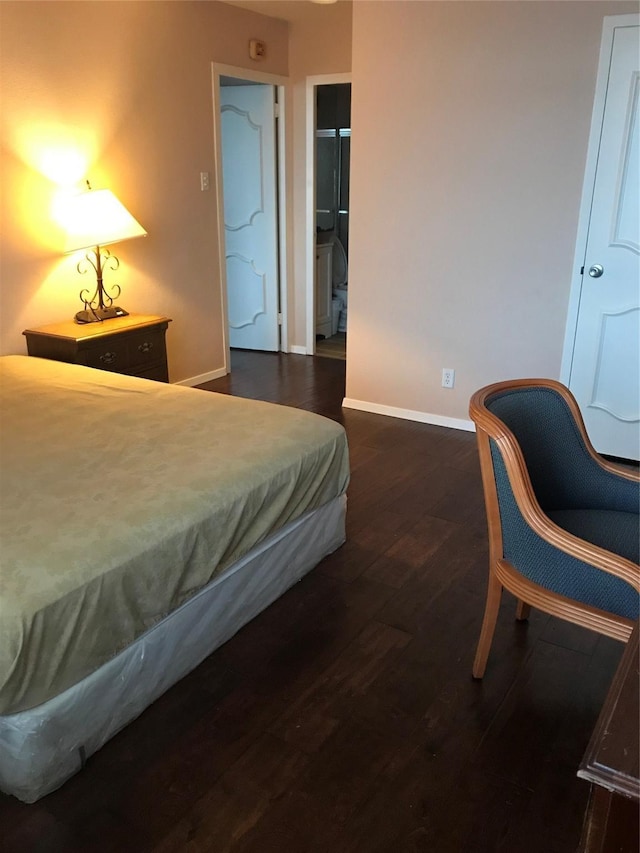 7510 Hornwood Dr Unit 201, Houston, TX 77036 - bedroom with baseboards and dark wood-style flooring