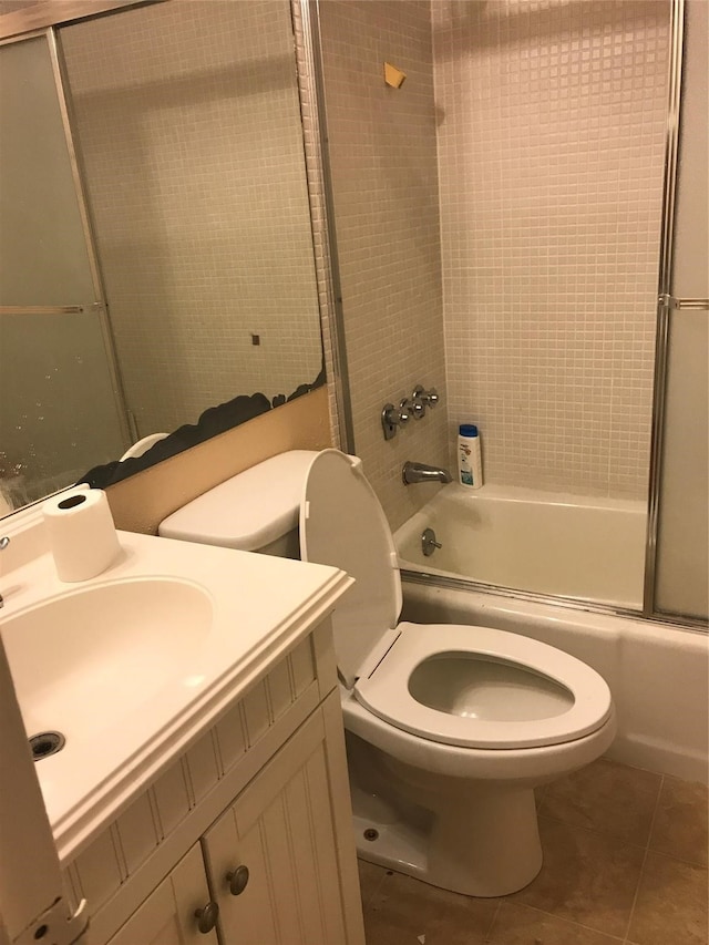 full bathroom featuring tile patterned flooring, toilet, enclosed tub / shower combo, and vanity