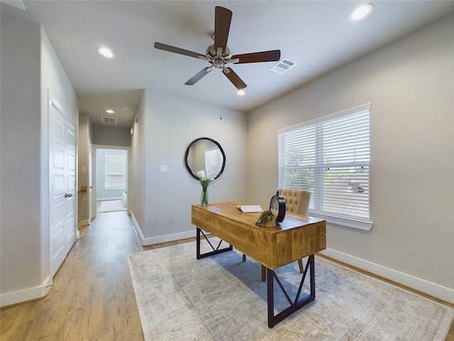 office space with light hardwood / wood-style floors and ceiling fan