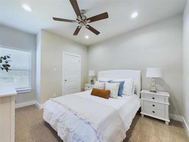 bedroom featuring ceiling fan and light carpet