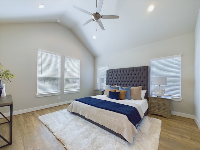 bedroom with ceiling fan, light wood-type flooring, and vaulted ceiling