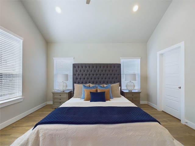 bedroom featuring vaulted ceiling and light hardwood / wood-style flooring