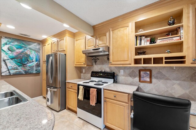 kitchen featuring electric stove, light brown cabinetry, decorative backsplash, stainless steel refrigerator, and light tile patterned floors