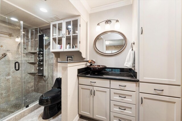 bathroom featuring an enclosed shower, crown molding, tile patterned floors, toilet, and vanity