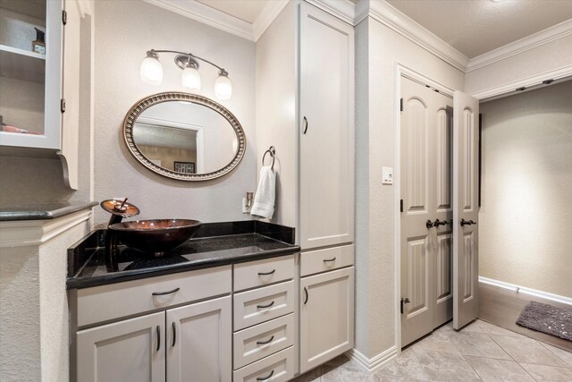 bathroom featuring vanity, crown molding, and tile patterned flooring