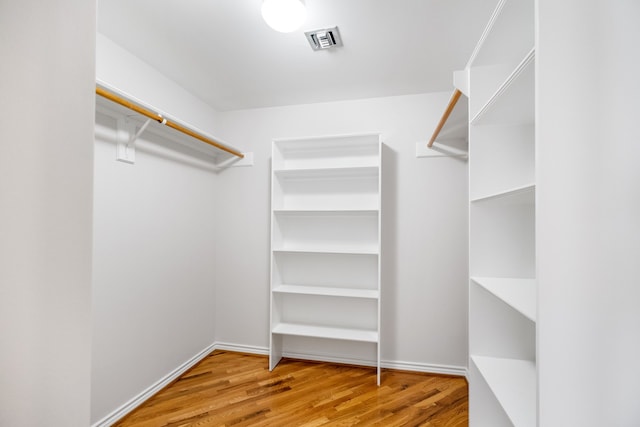 walk in closet featuring hardwood / wood-style flooring