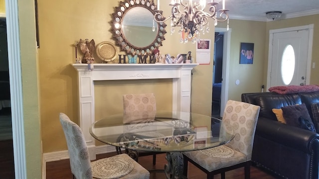 dining area with ornamental molding, an inviting chandelier, and hardwood / wood-style floors