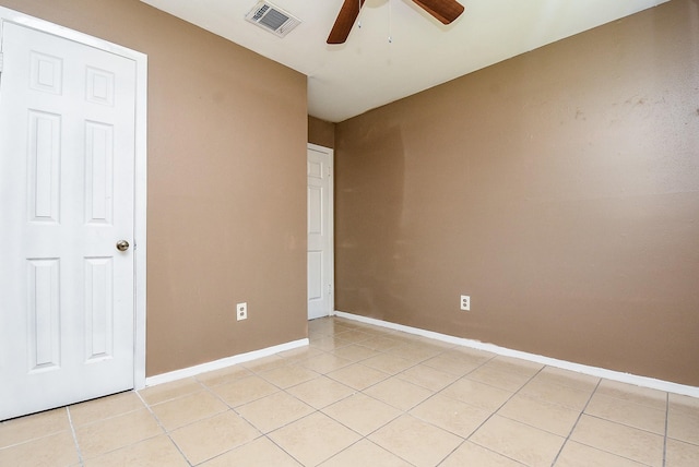 unfurnished bedroom with light tile patterned floors and ceiling fan