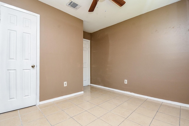 unfurnished bedroom with a ceiling fan, visible vents, baseboards, and light tile patterned floors