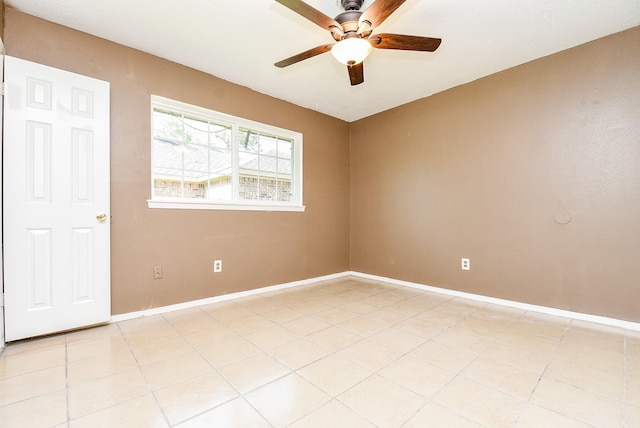 tiled spare room featuring ceiling fan