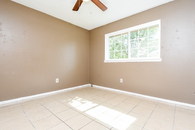 spare room featuring light tile patterned floors and ceiling fan