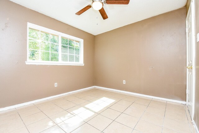 tiled spare room featuring ceiling fan and plenty of natural light