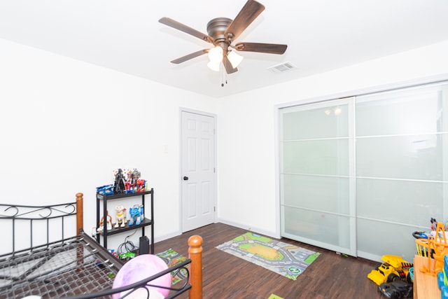 game room with dark hardwood / wood-style flooring and ceiling fan