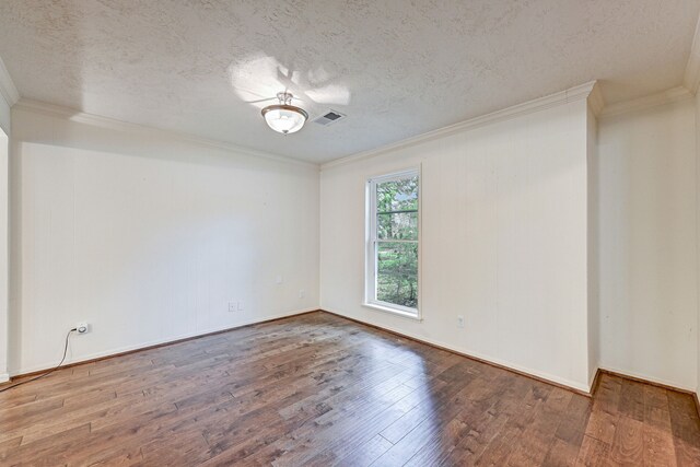 spare room featuring a textured ceiling, hardwood / wood-style floors, and crown molding