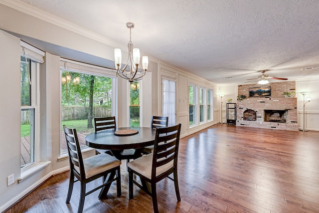 dining space with a fireplace, dark hardwood / wood-style flooring, and a textured ceiling