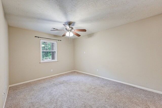 empty room with a textured ceiling, ceiling fan, and carpet floors