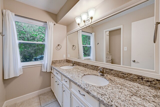 bathroom with double vanity and tile patterned floors