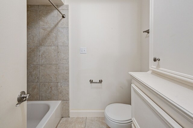 full bathroom featuring tile patterned floors, tiled shower / bath combo, vanity, and toilet