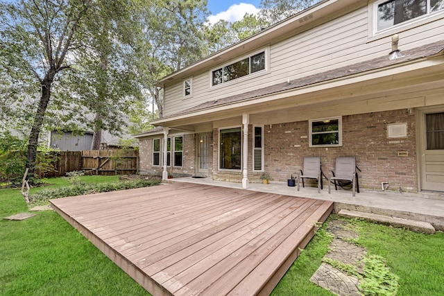 wooden terrace featuring a yard