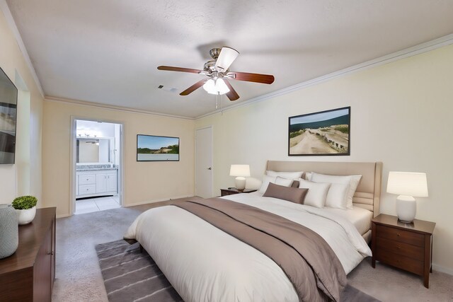 bedroom with connected bathroom, ceiling fan, crown molding, and carpet floors