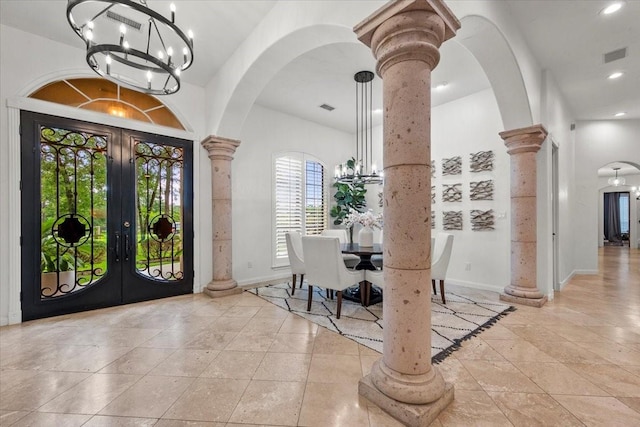 9819 Crestwater Cir, Magnolia, TX 77354 - entryway featuring a chandelier, ornate columns, french doors, arched walkways, and baseboards