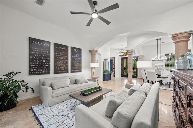 9819 Crestwater Cir, Magnolia, TX 77354 - living room featuring arched walkways, ornate columns, a chandelier, a ceiling fan, and light tile patterned floors