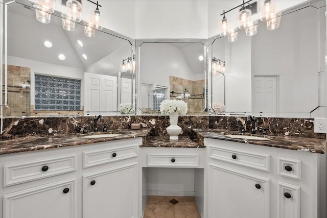 9819 Crestwater Cir, Magnolia, TX 77354 - bathroom featuring double vanity, a shower stall, vaulted ceiling, recessed lighting, and tile patterned floors